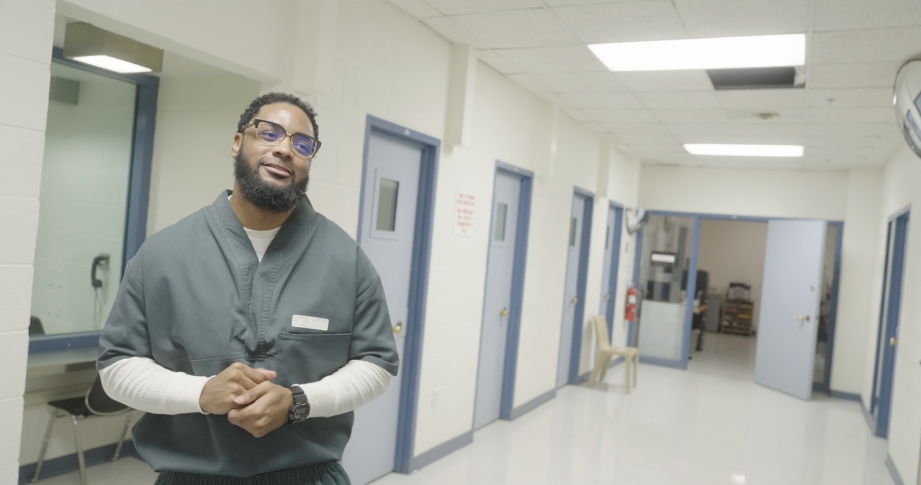 A participant speaking in a hallway inside the correctional facility