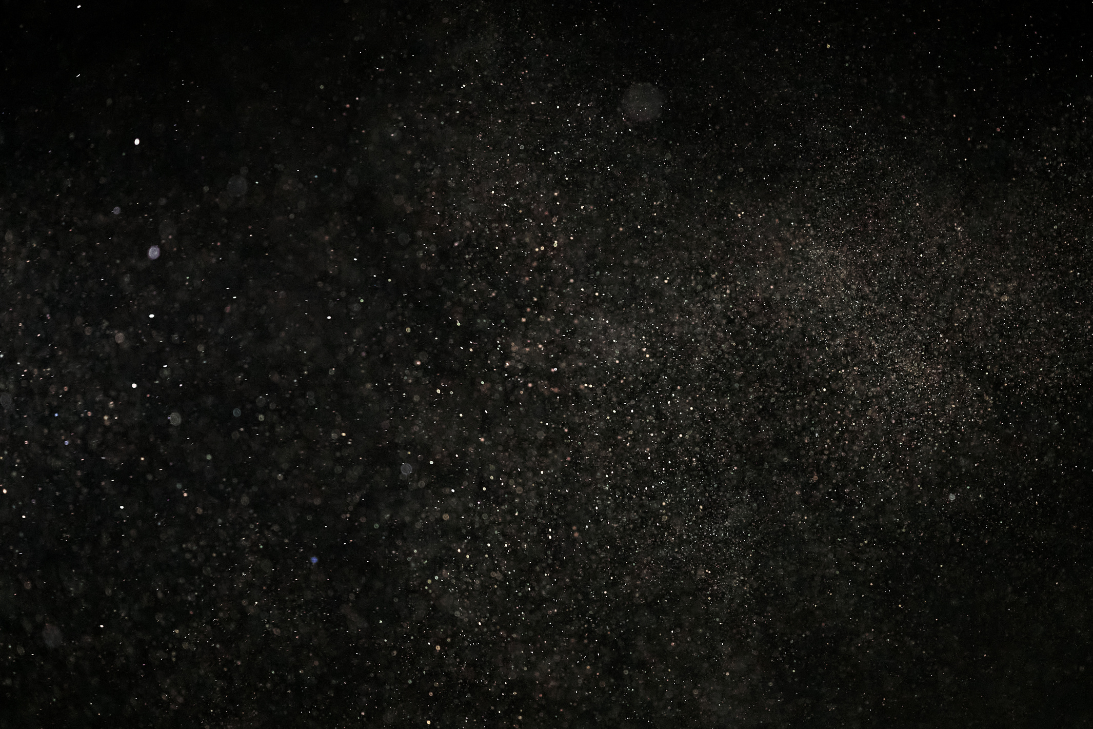White Dust Particles on Black Background